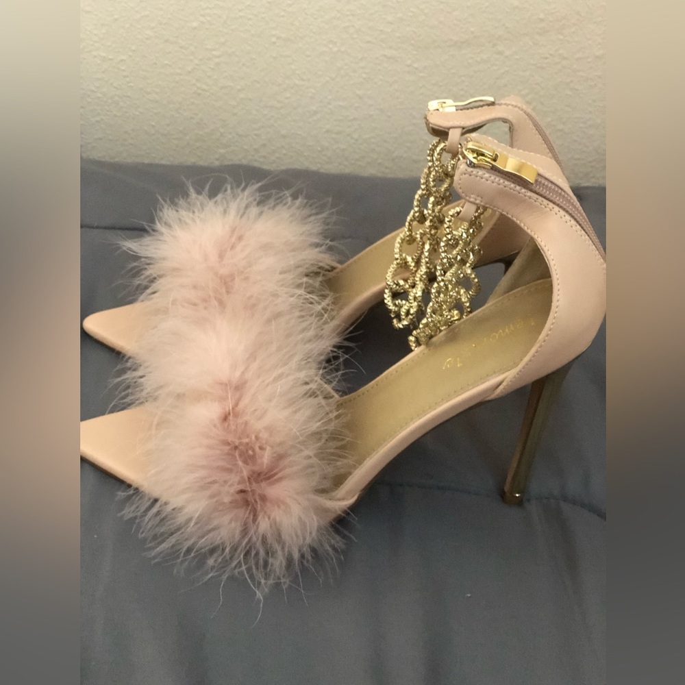 Light pink heels with gold chain anklets with some fur.